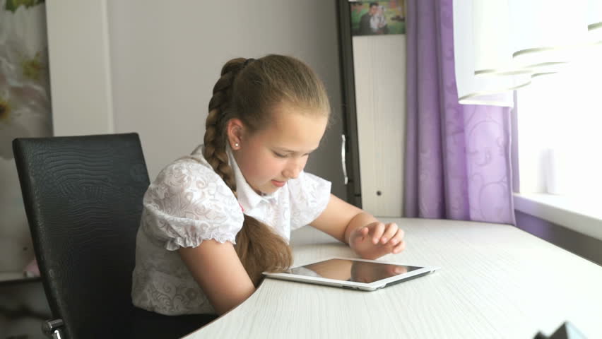 Schoolgirl uses a digital tablet computer at home | Shutterstock HD Video #20108029