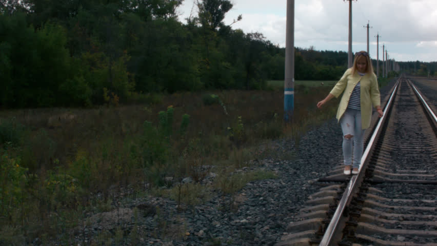 girl walking on rail road bridge 5