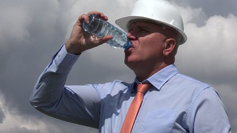 Engineer Hot Working Day in a Building Site Businessman with Thermal Discomfort Drink Water.