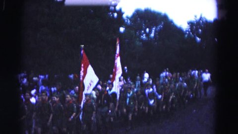 HAGERSTOWN, MARYLAND 1966: shows a parade of boy scout troop marching down street with flags.