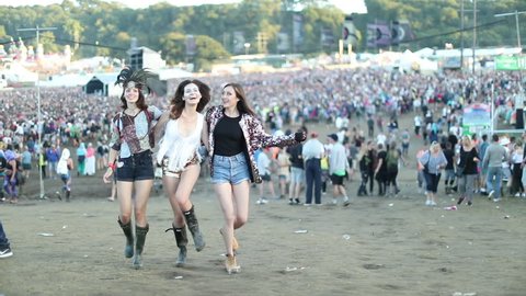 Young adult female friends having fun at festival