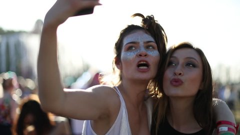 Female friends taking selfie at summer festival
