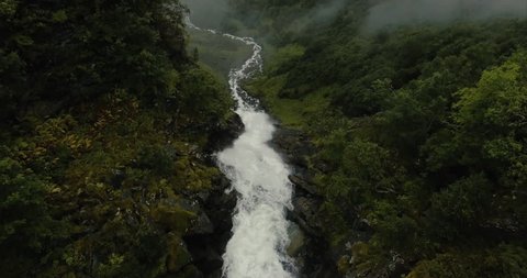 Dramatic reveal of a huge mountain waterfall located near Geiranger Fjord, Norway