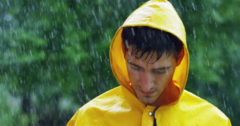 charming guy stares in the rain.
concept of passion for nature, seriousness and simplicity