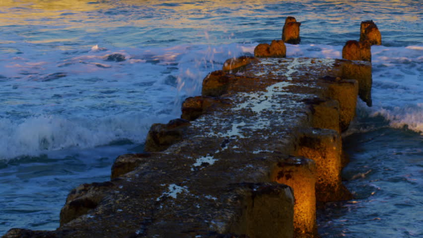 An old, ruined pier at the Mediterranean Sea shot in Israel.
