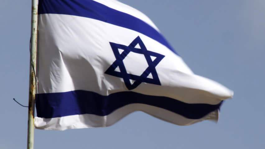 An Israeli flag waving in the breeze filmed in Israel.