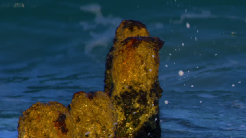 Waves over a ruined pier on the Mediterranean shot in Israel.