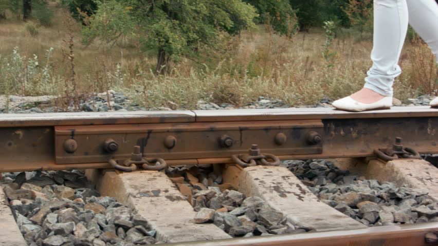 girl walking on the railroad