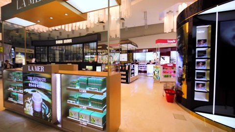 KUALA LUMPUR, MALAYSIA - APRIL 7, 2016: Stores of different beauty brands in duty free zone in KL Internationl airport: Lamer, Bobbi Brown, Bvlcari, Gucci, Biotherm, SK-II, Giorgio Armani, etc