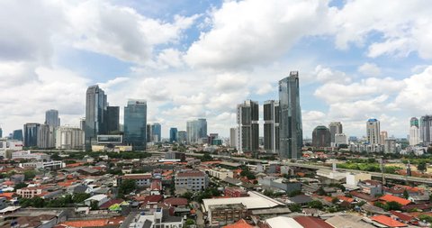 Time lapse, with a panning to the right, of clouds moving above the business district between Kuningan and Sudirman in downtown Jakarta, Indonesia capital city on the Java island.