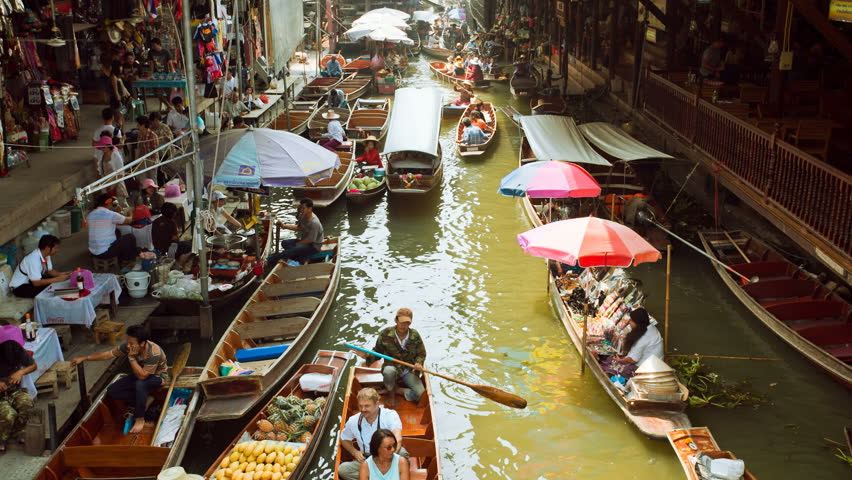 DAMNOEN SADUAK, THAILAND - FEBRUARY 25: Tourists are doing boat rides at the