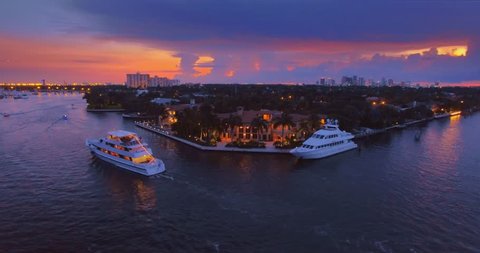 Miami cityscape at sunset, yachts and boats commuting on river. Hollywood, Miami, Florida, 4K UHD aerial view. 