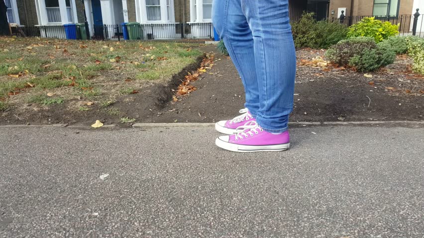 Female feet walking in the street