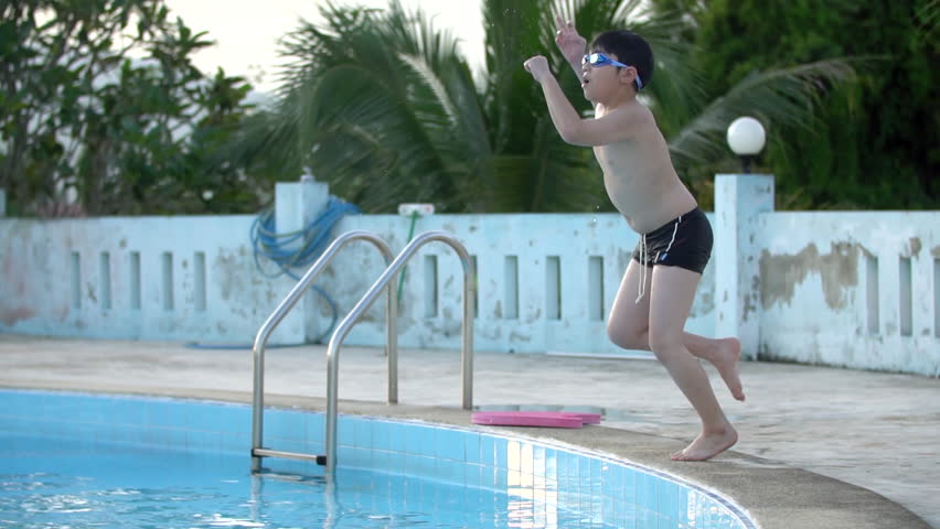 Slow motion of asian child playing in pool, Happy boy having fun on vacation.
