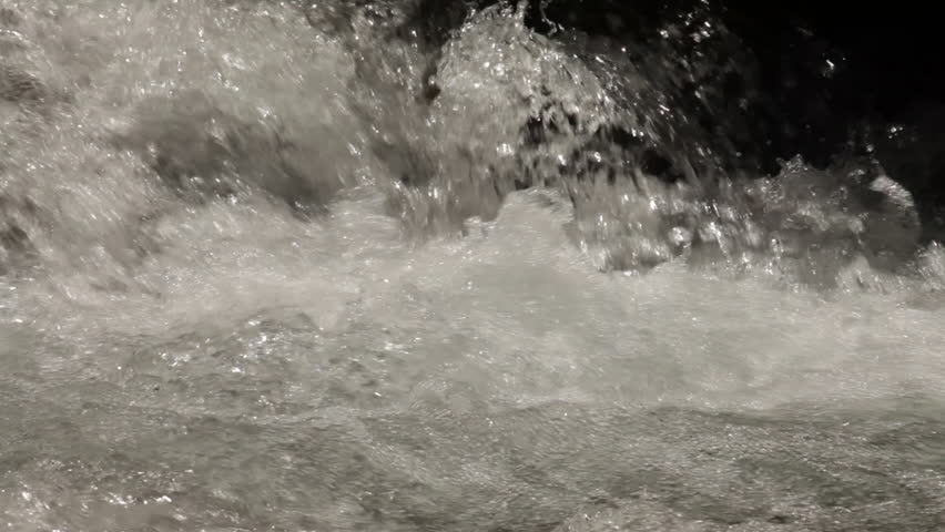 Stationary close-up of fast-flowing river