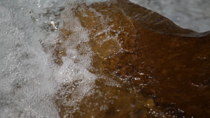 Water washing a rock in a stream