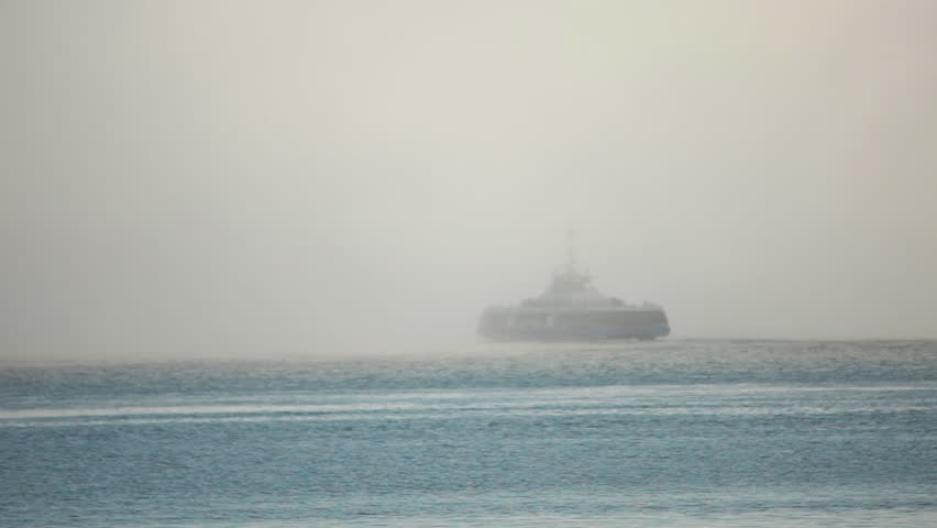 Ferry disappearing into fog