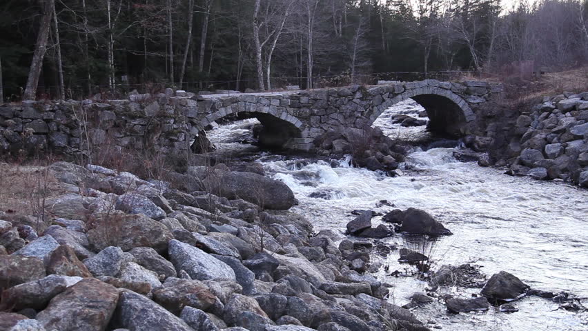 Small river under stone bridge