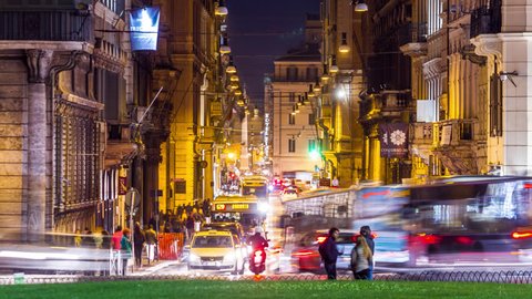 Night timelapse of Corso street with people crowd and car traffic. Rome, Italy. April, 2016. Time lapse.