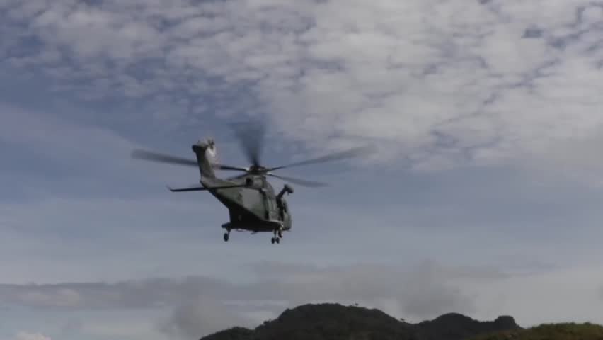 view from rear blackhawk flying off into mountain region