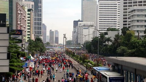 JAKARTA, INDONESIA - SEPTEMBER 25, 2016: People enjoy the car free day, which happens every Sunday morning, on Jalan Sudirman in Indonesia capital city business district.
