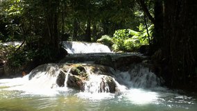 Beautiful nature of Thailand jungle rain forest with tropical plants and waterfalls of small mountain river running among stones and rocks