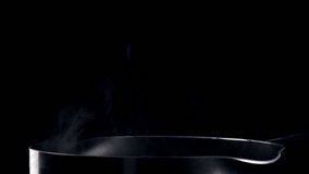 Pasta being poured into a pot of boiling water. Shot with a high speed camera.