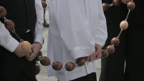 BOYS WITH GIANT ROSARY