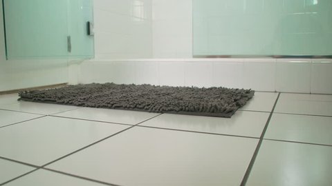Woman drops towel as she enters shower