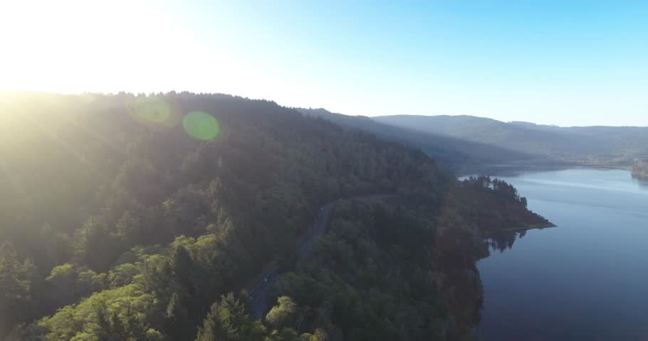 Aerial shot of a car driving on a State Route 1 - the Pacific Coast Highway in California, USA