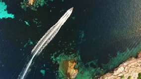 Boat while sailing on the sea, a suggestive perpendicular aerial video flying on a boat in incredible seascape, mediterranean sea
