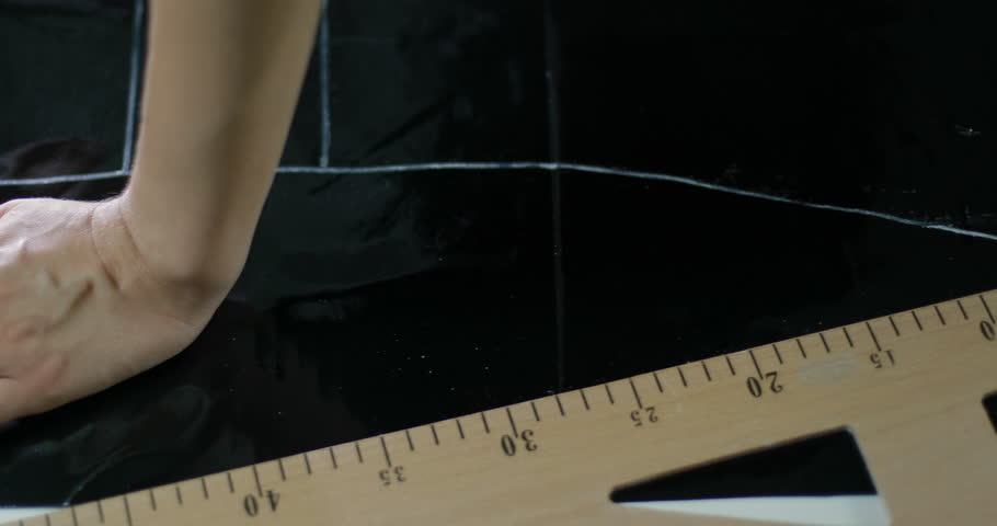 Female designer draws a dotted line on the leatherette. tracking shot. in slow motion