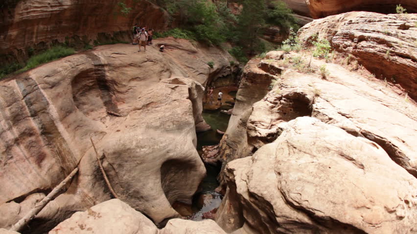 Hikers going down a cliff in the Zion National Park