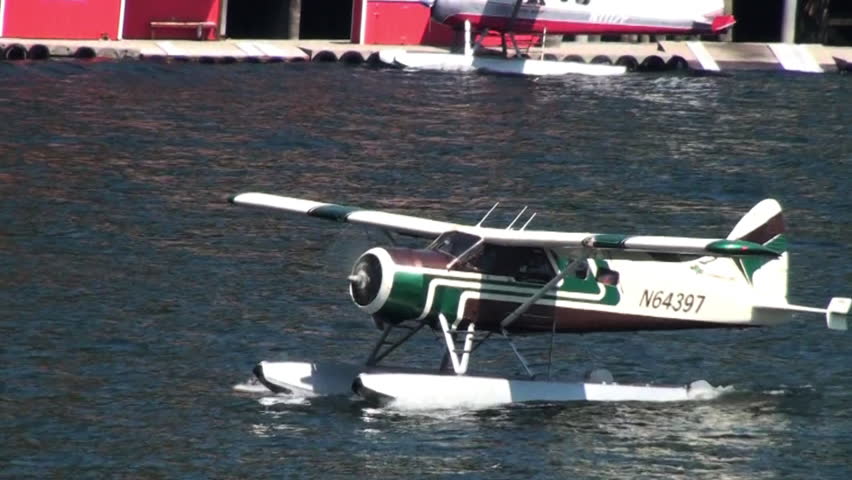ALASKA, USA - CIRCA 2011; Green float-plane taking off