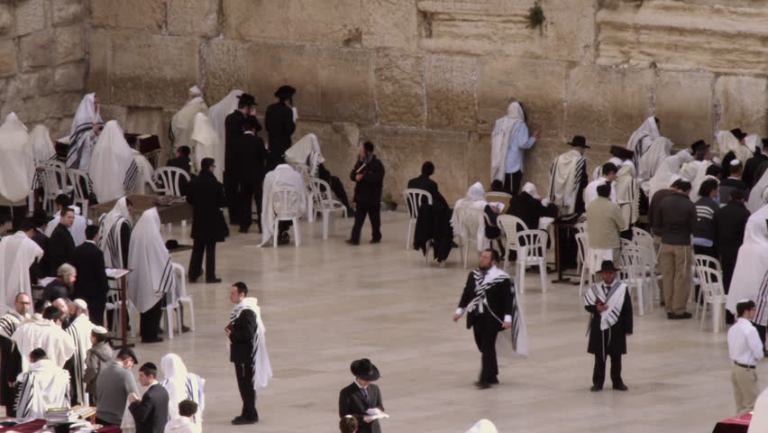 JERUSALEM, ISRAEL - CIRCA 2011; Jews praying at the Western Wall filmed in