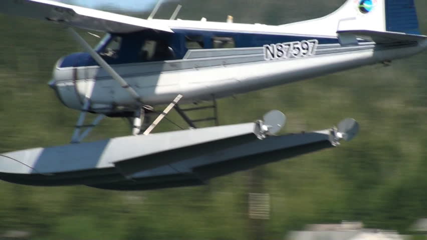 ALASKA, USA - CIRCA 2011; Blue float-plane coming in for a landing