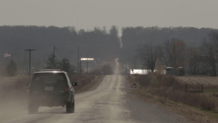 A Car Going Down a Country Road in Iowa