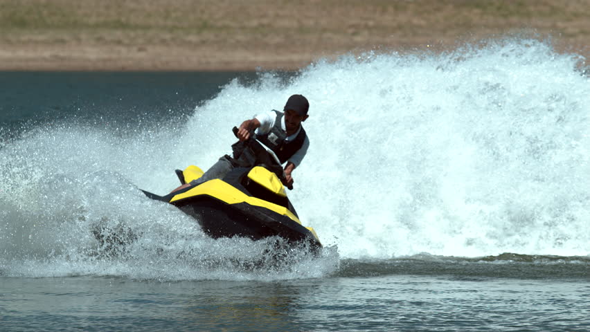 Man riding personal water craft on lake, super slow motion, shot on Phantom Flex 4K Royalty-Free Stock Footage #20207923