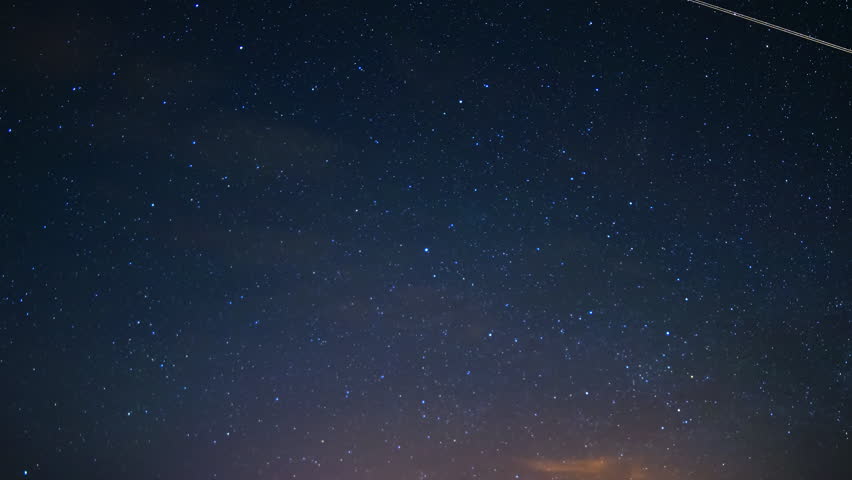Astrophotography time lapse with zoom out motion of starry sky covered by clouds over Sedona, Arizona