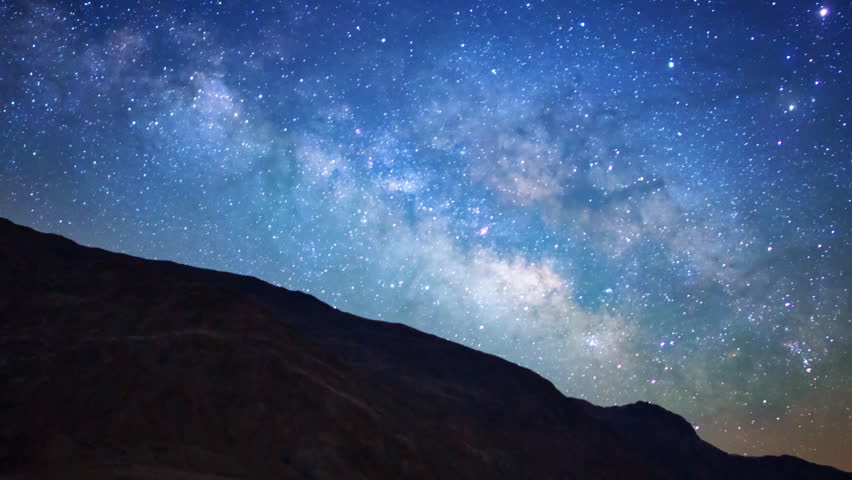 Motion controlled astrophotography time lapse with dolly down/left, pan right & zoom out motion of Milky Way galaxy over Badwater Salt Flat in Death Valley National Park, California