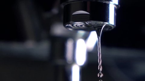 Dripping faucet. Leakage concept. Super slow motion extreme close up shot
