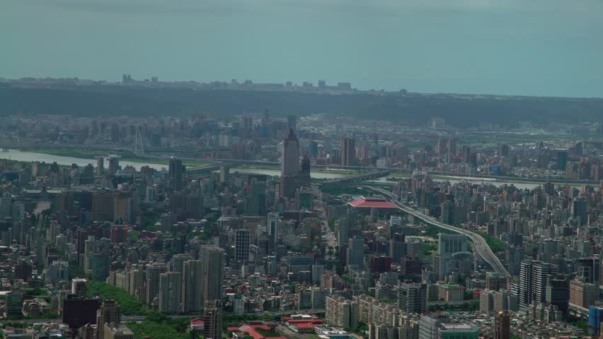 4K Aerial view of the Downtown Taipei city buildings with mountains and clouds background from above of the building 101, West Area cityscape High Angle with Skyline of Taiwan Capital Daytime-Dan