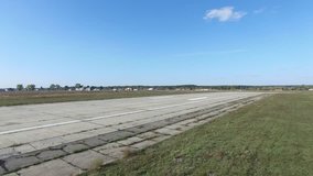 Light aircraft landed at the airport. A single-engine airplane sits on a sunny day. Landing two-seater. Shooting the drone landing aircraft.