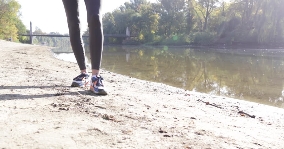 Woman taking selfie picture using smart phone photo camera outdoor river shore, curly hair girl morning autumn park natural sun lights slow motion 60
