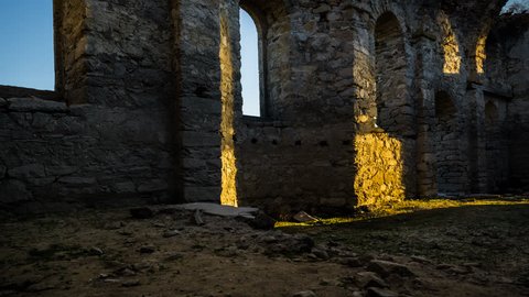 4K Tracking, panning and tilting timelapse of the interior of an old church with moving shadows during sunset.