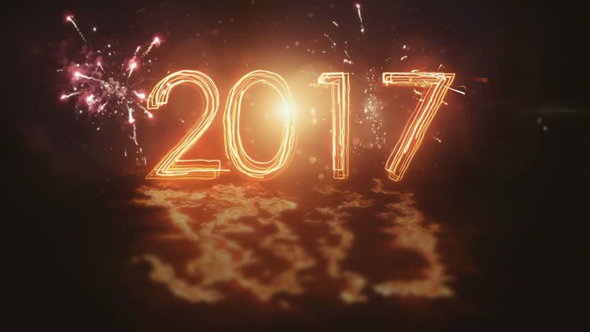 Happy New Year 2017 inscription sparklers on a black background . Fireworks on the background.