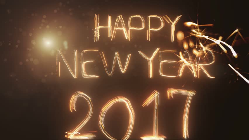 Happy New Year 2017 inscription sparklers on a black background .