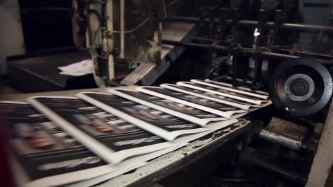 Newspaper being printed in printing press