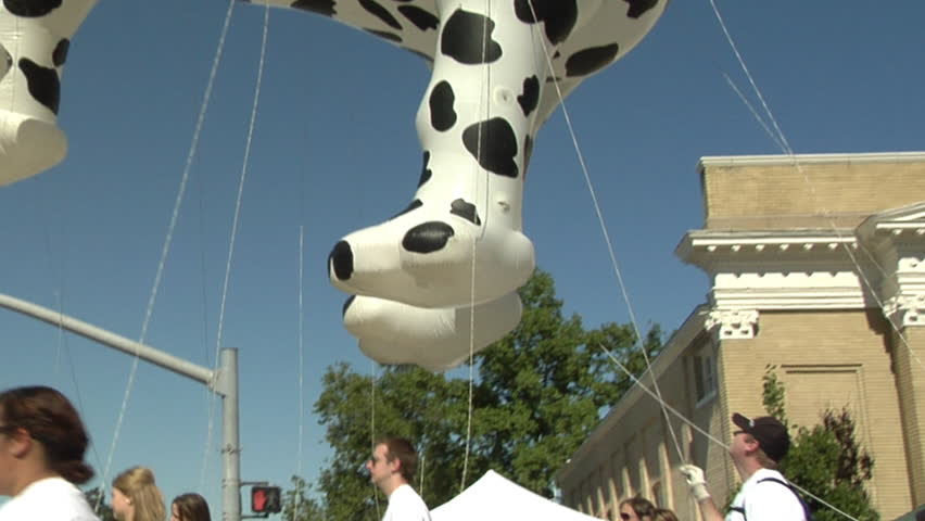 UTAH - CIRCA 2011: Unidentified people holding the lines of a giant dog balloon