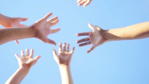 Successful team: many hands holding together on sky background in slowmotion. 1920x1080